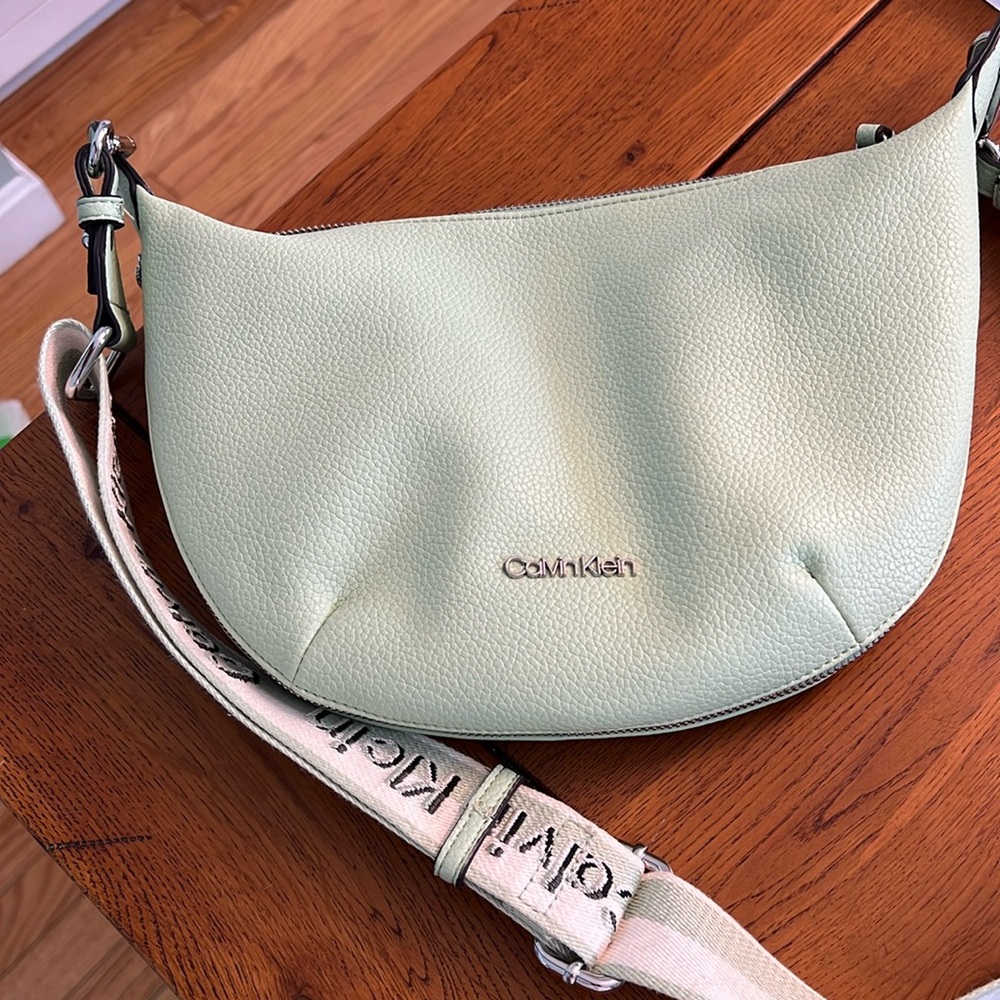 Calvin Klein shoulder bag with adjustable strap. Silver accents.